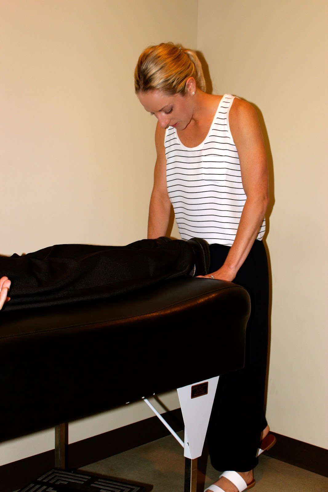 A Roots practitioner working with a patient during a focused adjustment